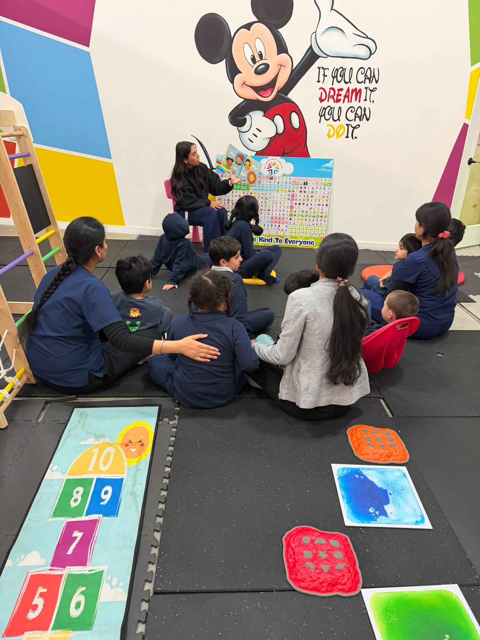 Speech therapist working with children using visual communication supports at My Empower Therapy